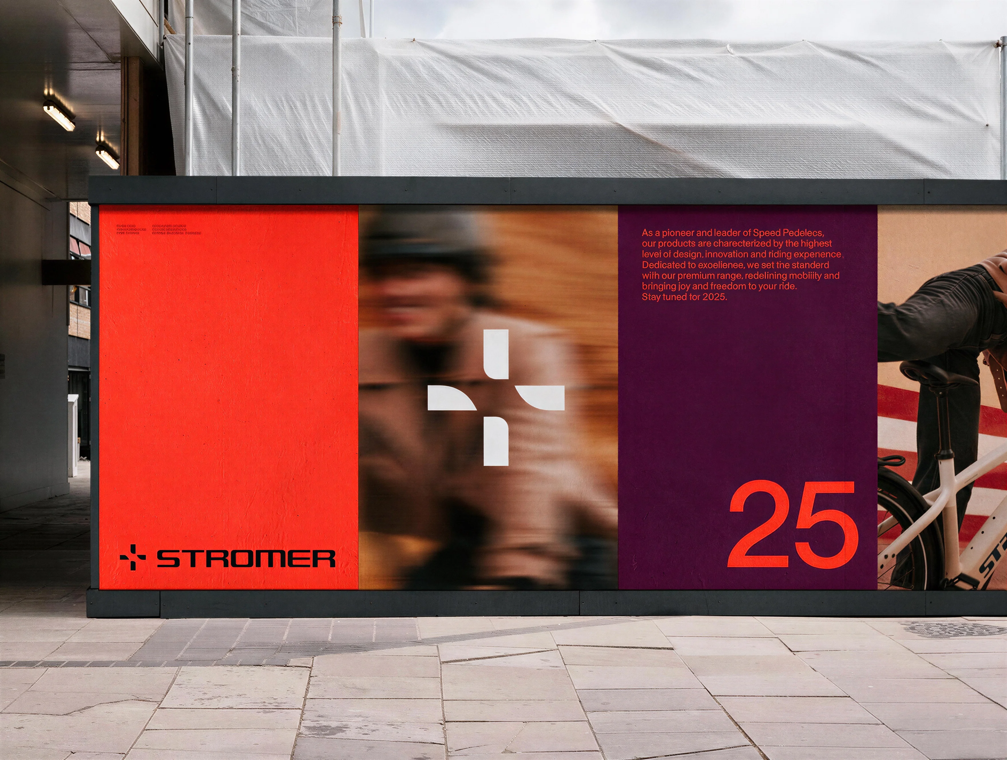 A street billboard showing the Stromer brand identity — a red panel with the logo, a blurred rider, and a dark red panel with the number 25.